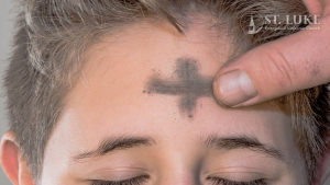 Imposition of ash cross on person's forehead